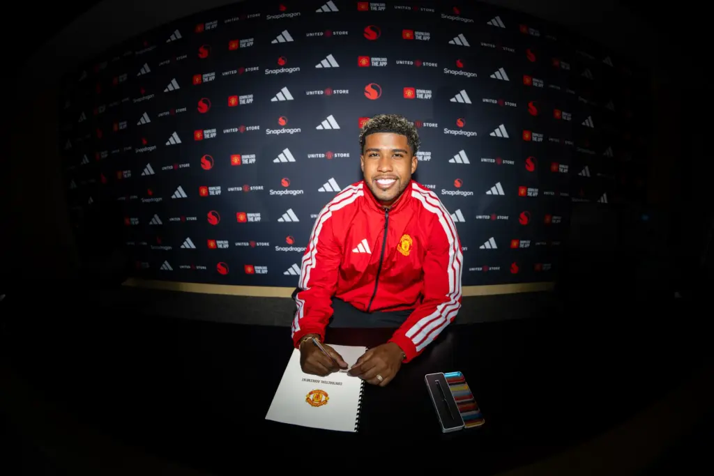Andrey Santos signs his Manchester United contract. Image: MUFC