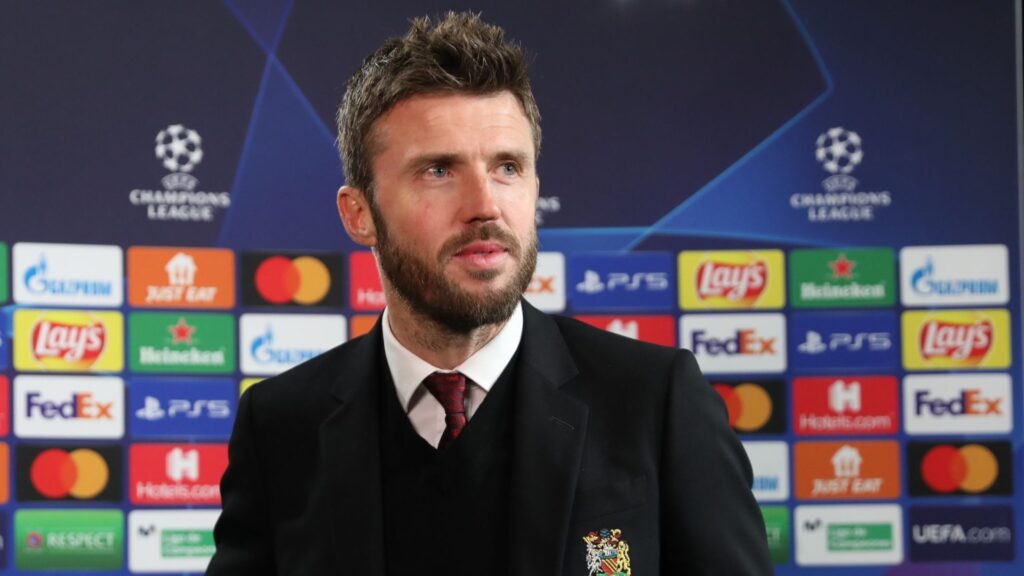 Michael Carrick in a suit during a media conference.