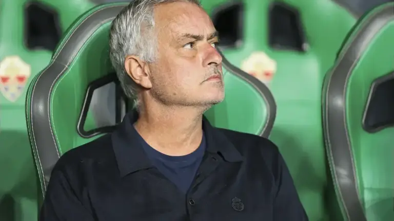 Jose Mourinho Man City titles: Jose Mourinho seated on the bench during a match.